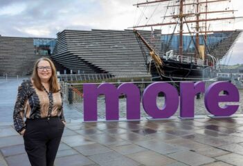 Angela Wallace standing in front of V&A Dundee and The RRS Discovery Ship.