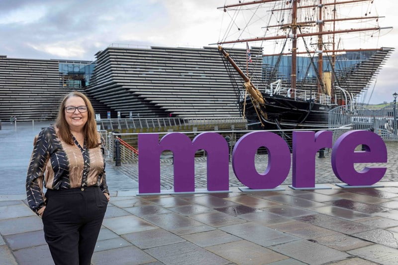 Angela Wallace standing in front of V&A Dundee and The RRS Discovery Ship.